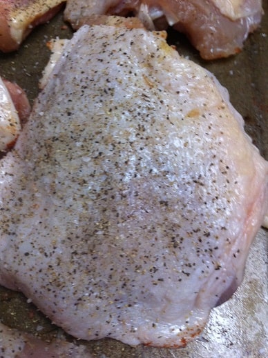 Chicken thighs seasoned with salt and pepper