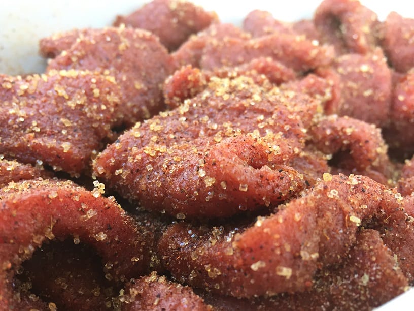 Brisket strips mixed with jerky cure
