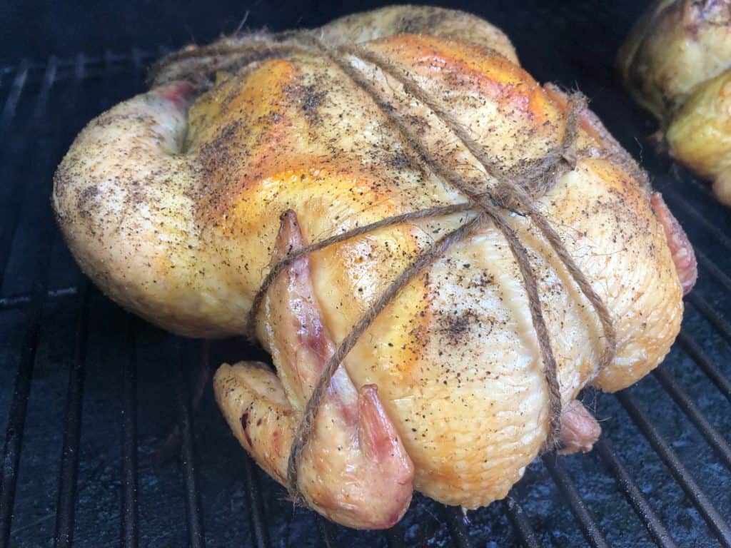 Whole chicken smoking on a Z Grills Pellet Grill